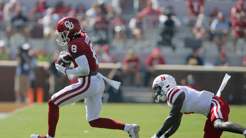 Oklahoma's Michael Woods II (8) catches the ball in front of of Nebraska's Cam Taylor-Britt (5) during a college football game between the University of Oklahoma Sooners (OU) and the Nebraska Cornhuskers at Gaylord Family-Oklahoma Memorial Stadium in Norman, Okla., Saturday, Sept. 18, 2021.

Lx14541