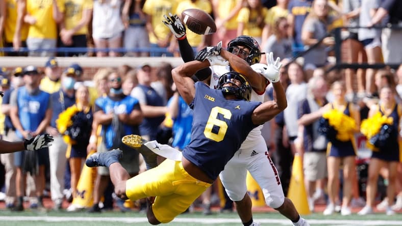 Sep 18, 2021; Ann Arbor, Michigan, USA; Northern Illinois Huskies cornerback Jordan Gandy (14) breaks up a pass to Michigan Wolverines wide receiver Cornelius Johnson (6) in the first half at Michigan Stadium. Mandatory Credit: Rick Osentoski-USA TODAY Sports