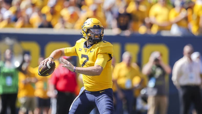 Sep 18, 2021; Morgantown, West Virginia, USA; West Virginia Mountaineers quarterback Jarret Doege (2) throws a pass during the first quarter against the Virginia Tech Hokies at Mountaineer Field at Milan Puskar Stadium. Mandatory Credit: Ben Queen-USA TODAY Sports