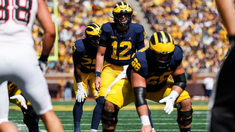 Michigan quarterback Cade McNamara (12) prepares for a snap against Northern Illinois during the first half at Michigan Stadium in Ann Arbor on Saturday, Sept. 18, 2021.