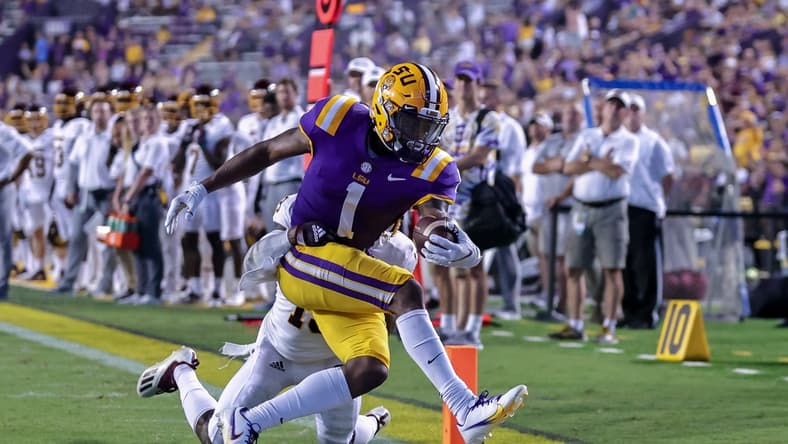 Sep 18, 2021; Baton Rouge, Louisiana, USA; LSU Tigers wide receiver Kayshon Boutte (1) makes a 2 yard touchdown reception against Central Michigan Chippewas defensive back Donte Kent (19) during the first half at Tiger Stadium. Mandatory Credit: Stephen Lew-USA TODAY Sports