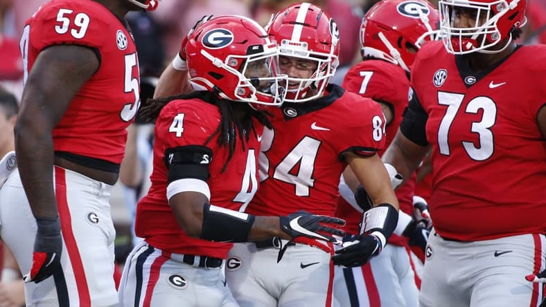 Sep 18, 2021; Athens, Georgia, USA; Georgia Bulldogs running back James Cook (4) celebrates with his teammates after scoring a touchdown against the South Carolina Gamecocks during the first half at Sanford Stadium. Mandatory Credit: Joshua L. Jones/Athens Banner-Herald via USA TODAY NETWORK