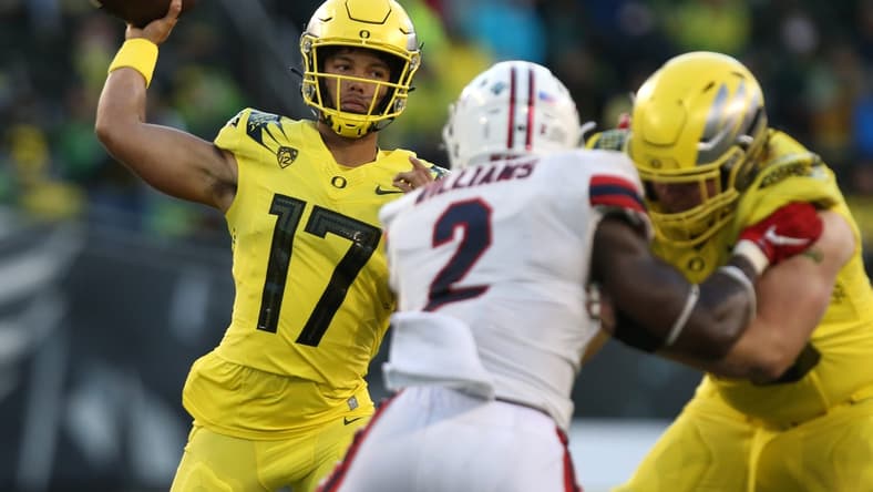 Oregon's Ty Thompson, left, throws down field against Stony Brook during the third quarter.
Eug 091821 Oregonfb 14