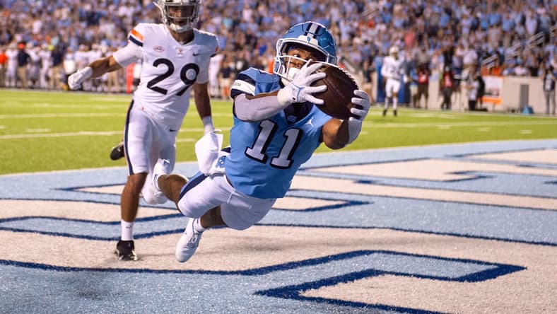 Sep 18, 2021; Chapel Hill, North Carolina, USA; North Carolina Tar Heels wide receiver Josh Downs (11) catches a touchdown in the end zone as Virginia Cavaliers free safety Joey Blount (29) defends in the first quarter at Kenan Memorial Stadium. Mandatory Credit: Bob Donnan-USA TODAY Sports