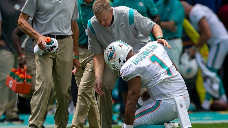 Miami Dolphins Miami Dolphins quarterback Tua Tagovailoa (1), falls to the ground as he ties to leave the field after being sacked by Buffalo Bills offensive tackle Daryl Williams (75) during first quarter action of their NFL game at Hard Rock Stadium Sunday in Miami Gardens. Tagovailoa did not return to action. BILL INGRAM/ Palm Beach PostDolphins V Bills 02