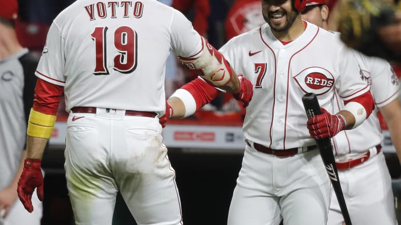 Sep 20, 2021; Cincinnati, Ohio, USA; Cincinnati Reds first baseman Joey Votto (19) reacts with third baseman Eugenio Suarez (7) after hitting a solo home run against the Pittsburgh Pirates during the fifth inning at Great American Ball Park. Mandatory Credit: David Kohl-USA TODAY Sports
