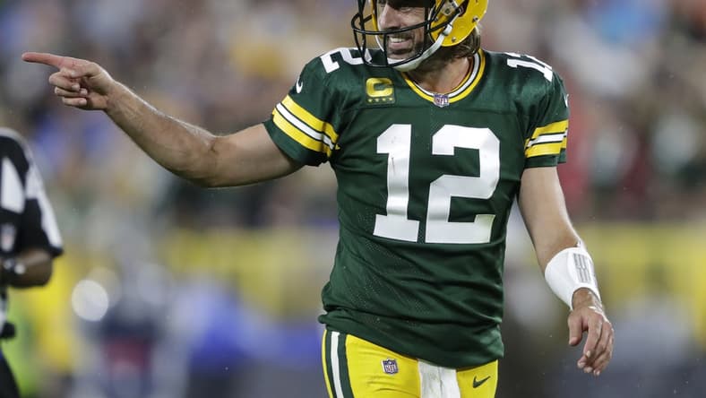 Sep 20, 2021; Green Bay, WIsconsin, USA; Green Bay Packers quarterback Aaron Rodgers (12) celebrates after a pass completion to wide receiver Davante Adams (not pictured) against the Detroit Lions at Lambeau Field. Mandatory Credit: Dan Powers/Appleton Post-Crescent via USA TODAY NETWORK
