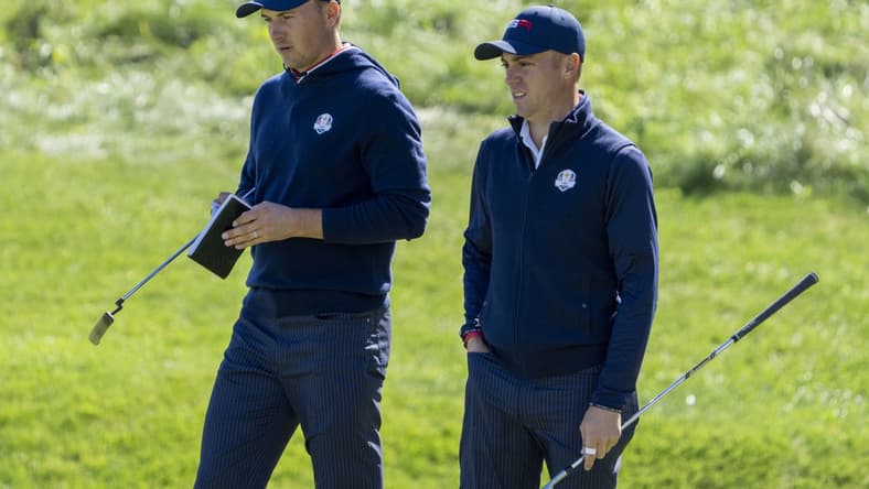 September 22, 2021; Haven, Wisconsin, USA; Team USA players Jordan Spieth (left) and Justin Thomas (right) look on at the 18th green during a practice round for the 43rd Ryder Cup golf competition at Whistling Straits. Mandatory Credit: Kyle Terada-USA TODAY Sports