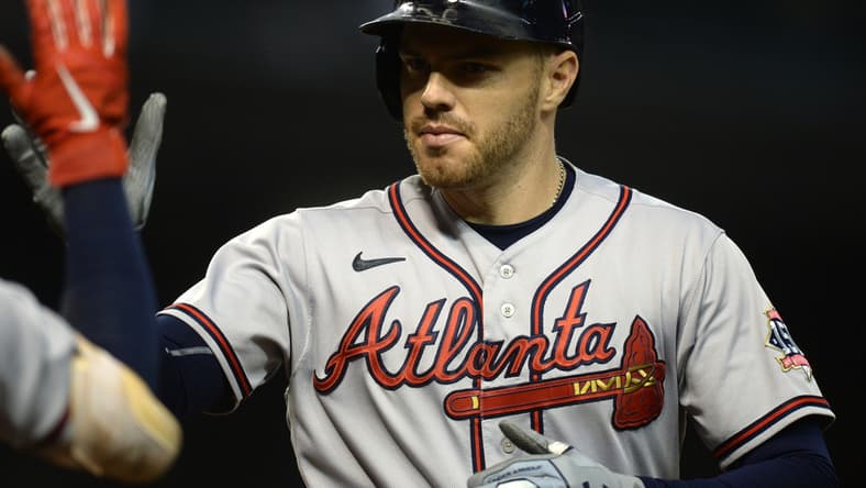 Sep 22, 2021; Phoenix, Arizona, USA; Atlanta Braves first baseman Freddie Freeman (5) celebrates after hitting a home run against the Arizona Diamondbacks during the ninth inning at Chase Field. Mandatory Credit: Joe Camporeale-USA TODAY Sports