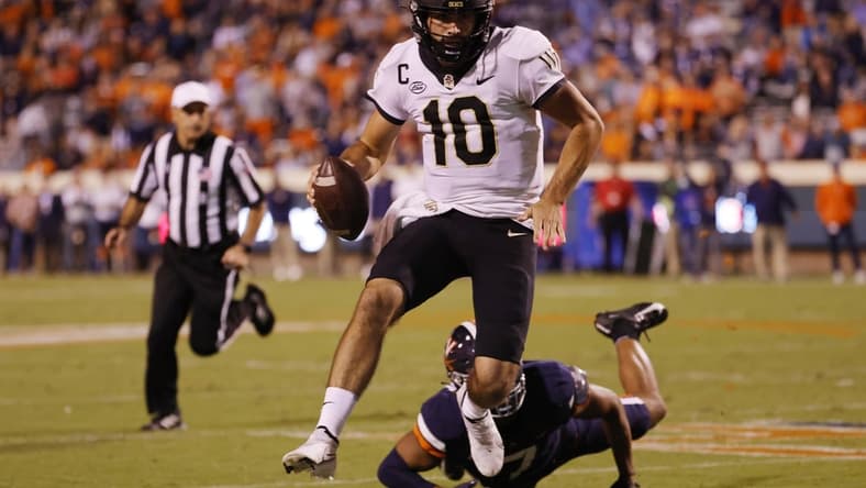 Sep 24, 2021; Charlottesville, Virginia, USA; Wake Forest Demon Deacons quarterback Sam Hartman (10) scrambles past Virginia Cavaliers outside linebacker Noah Taylor (7) during the second quarter at Scott Stadium. Mandatory Credit: Geoff Burke-USA TODAY Sports
