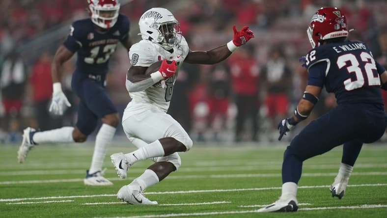 Sep 24, 2021; Fresno, California, USA; UNLV Rebels outside linebacker Kylan Wilborn (8) runs the ball against the Fresno State Bulldogs in the first quarter at Bulldog Stadium. Mandatory Credit: Cary Edmondson-USA TODAY Sports