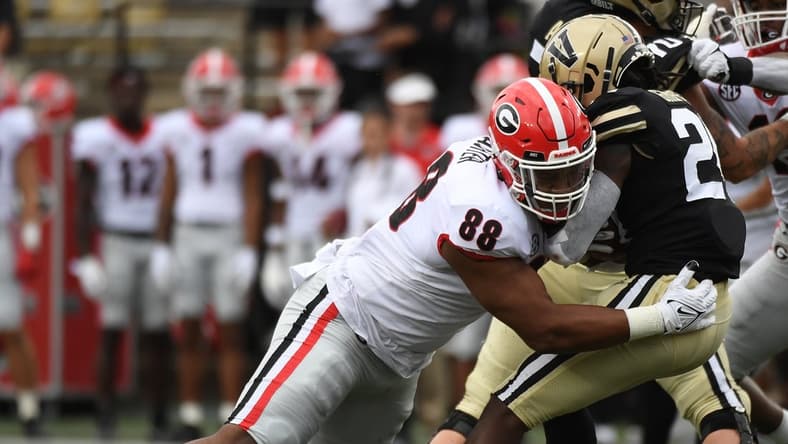 Sep 25, 2021; Nashville, Tennessee, USA; Georgia Bulldogs defensive lineman Jalen Carter (88) tackles Vanderbilt Commodores running back Rocko Griffin (24) for a loss during the first half at Vanderbilt Stadium. Mandatory Credit: Christopher Hanewinckel-USA TODAY Sports