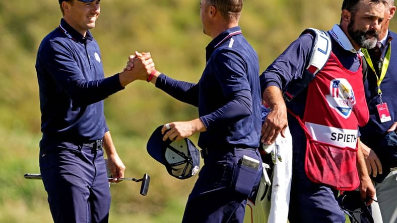 Sep 25, 2021; Haven, Wisconsin, USA; Team USA player Jordan Spieth and Team USA player Justin Thomas celebrate winning their match on the 18th green during day two foursomes rounds for the 43rd Ryder Cup golf competition at Whistling Straits. Mandatory Credit: Kyle Terada-USA TODAY Sports