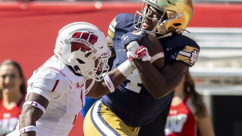 Sep 25, 2021; Chicago, Illinois, USA; Notre Dame Fighting Irish wide receiver Kevin Austin Jr. (4) receives a pass for a touchdown against Wisconsin Badgers cornerback Faion Hicks (1) during the first half at Soldier Field. Mandatory Credit: Patrick Gorski-USA TODAY Sports