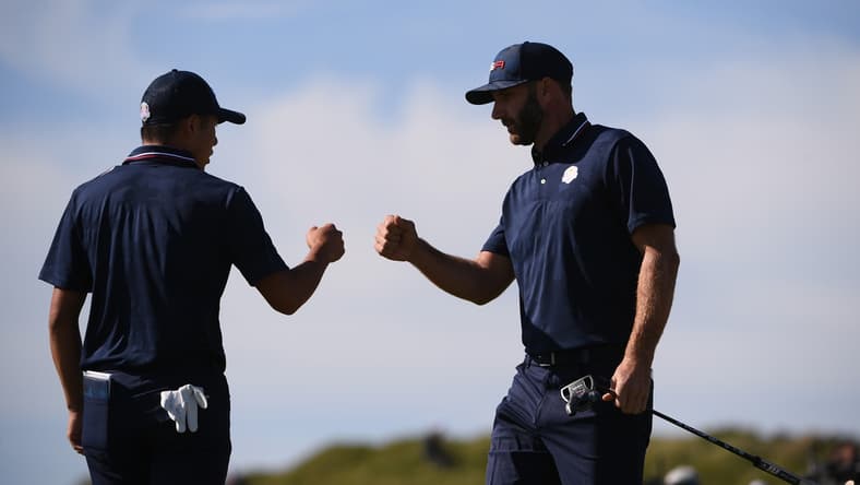 Sep 25, 2021; Haven, Wisconsin, USA; Team USA player Collin Morikawa and Team USA player Dustin Johnson bump fist after Joshnson's putt during day two foursomes rounds for the 43rd Ryder Cup golf competition at Whistling Straits. Mandatory Credit: Orlando Ramirez-USA TODAY Sports