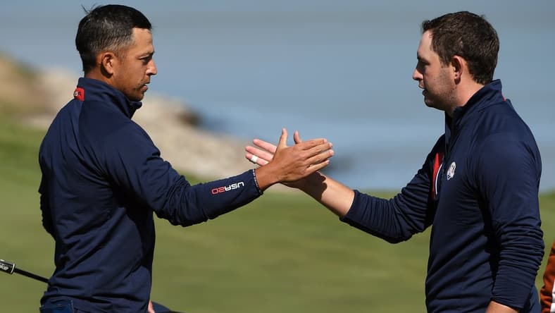 Sep 25, 2021; Haven, Wisconsin, USA; Team USA player Xander Schauffele shakes hands with Team USA player Patrick Cantlay after their win on the 17th green during day two foursomes rounds for the 43rd Ryder Cup golf competition at Whistling Straits. Mandatory Credit: Orlando Ramirez-USA TODAY Sports