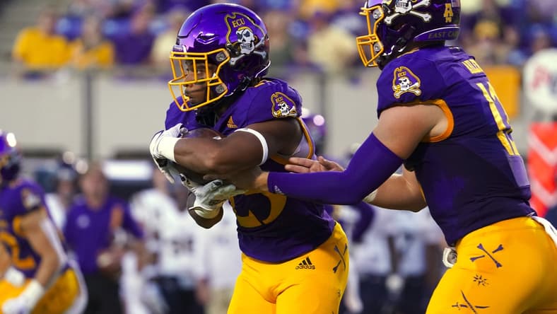 Sep 25, 2021; Greenville, North Carolina, USA; East Carolina Pirates running back Keaton Mitchell (25) scores a first-half touchdown against the Charleston Southern Buccaneers at Dowdy-Ficklen Stadium. Mandatory Credit: James Guillory-USA TODAY Sports