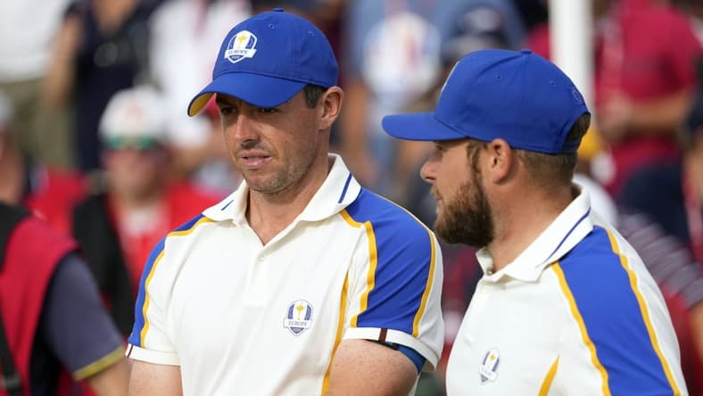 Sep 26, 2021; Haven, Wisconsin, USA; Team Europe player Rory McIlroy and Team Europe player Tyrrell Hatton look on from the 15th green during day three singles rounds for the 43rd Ryder Cup golf competition at Whistling Straits. Mandatory Credit: Michael Madrid-USA TODAY Sports