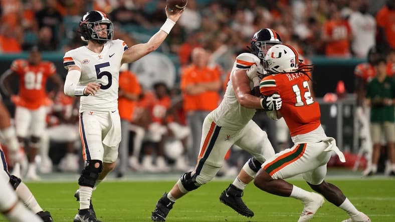 Sep 30, 2021; Miami Gardens, Florida, USA; Virginia Cavaliers quarterback Brennan Armstrong (5) attempts a pass against the Miami Hurricanes during the first half at Hard Rock Stadium. Mandatory Credit: Jasen Vinlove-USA TODAY Sports