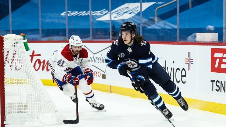 Feb 27, 2021; Winnipeg, Manitoba, CAN;   Winnipeg Jets defenseman Sami Niku (8) skates away from Montreal Canadiens forward Paul Byron (41) during the first period at Bell MTS Place. Mandatory Credit: Terrence Lee-USA TODAY Sports