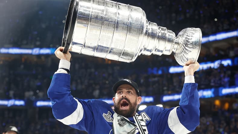 Jul 7, 2021; Tampa, Florida, USA; Tampa Bay Lightning left wing Alex Killorn (17) hoists the Stanley Cup after the Lightning defeated the Montreal Canadiens 1-0 in game five to win the 2021 Stanley Cup Final at Amalie Arena. Mandatory Credit: Kim Klement-USA TODAY Sports