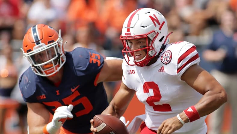 Aug 28, 2021; Champaign, Illinois, USA;  Nebraska Cornhuskers quarterback is pursued by Illinois fighting Illini linebacker Jake Hansen (35) during the first half at Memorial Stadium. Mandatory Credit: Ron Johnson-USA TODAY Sports
