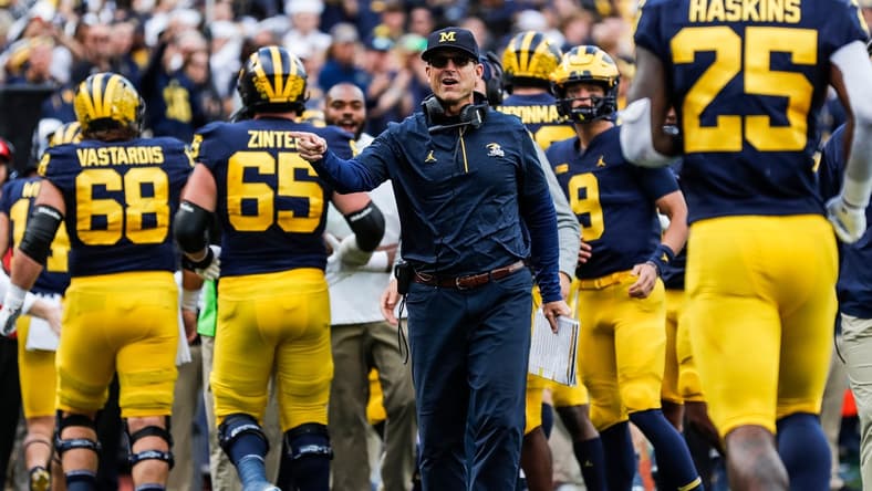 Michigan head coach Jim Harbaugh celebrates a touchdown against Rutgers during the first half at Michigan Stadium in Ann Arbor on Saturday, Sept. 25, 2021.