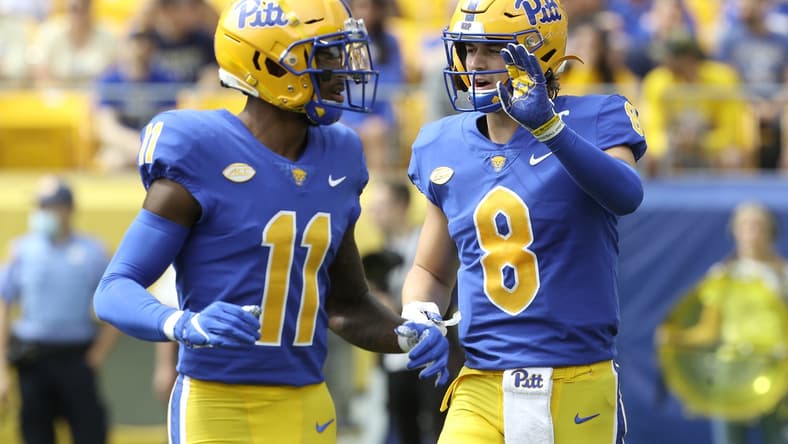 Sep 25, 2021; Pittsburgh, Pennsylvania, USA;  Pittsburgh Panthers wide receiver Taysir Mack (11) and quarterback Kenny Pickett (8) talk before a play against the New Hampshire Wildcats during the second quarter at Heinz Field. Mandatory Credit: Charles LeClaire-USA TODAY Sports