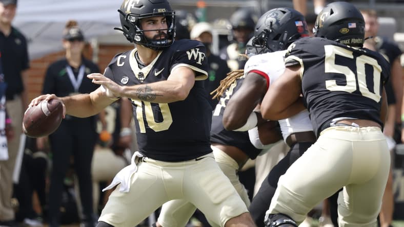 Oct 2, 2021; Winston-Salem, North Carolina, USA;  Wake Forest Demon Deacons quarterback Sam Hartman (10) throws a pass as offensive lineman Zach Tom (50) blocks during the first quarter against the Louisville Cardinals at Truist Field. Mandatory Credit: Reinhold Matay-USA TODAY Sports