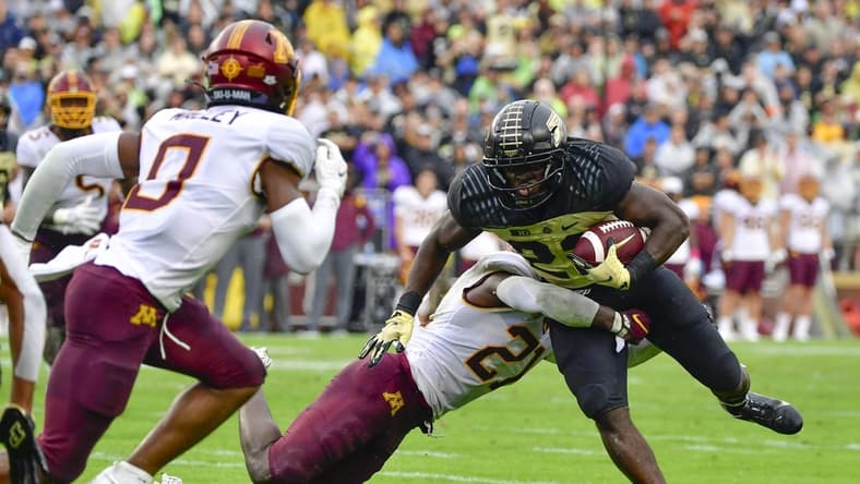 Oct 2, 2021; West Lafayette, Indiana, USA;  Purdue Boilermakers running back King Doerue (22) is tackled by Minnesota Golden Gophers defensive back Justus Harris (21) during the second quarter at Ross-Ade Stadium. Mandatory Credit: Marc Lebryk-USA TODAY Sports