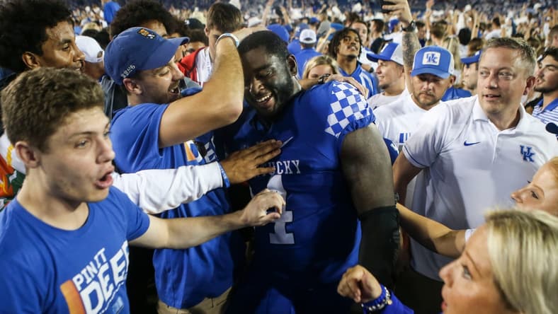 Kentucky's Joshua Paschal gets mobbed by fans after the Wildcats upset No. 10 Florida 20-13 at Kroger Field in Lexington. Paschal blocked a field goal in the second half which linebacker Trevin Wallace returned for a touchdown that sparked the Cats. Oct. 2, 2021
Kentucky Vs Florida October 2021