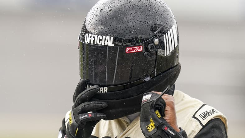Oct 3, 2021; Talladega, Alabama, USA; NASCAR Cup Series official has rain beading up on his helmet prior to the postponing of the race  at Talladega Superspeedway. Mandatory Credit: Marvin Gentry-USA TODAY Sports