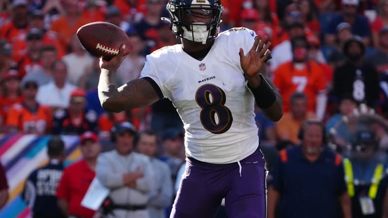 Oct 3, 2021; Denver, Colorado, USA; Baltimore Ravens quarterback Lamar Jackson (8) prepares to pass the ball in the third quarter against the Denver Broncos at Empower Field at Mile High. Mandatory Credit: Ron Chenoy-USA TODAY Sports