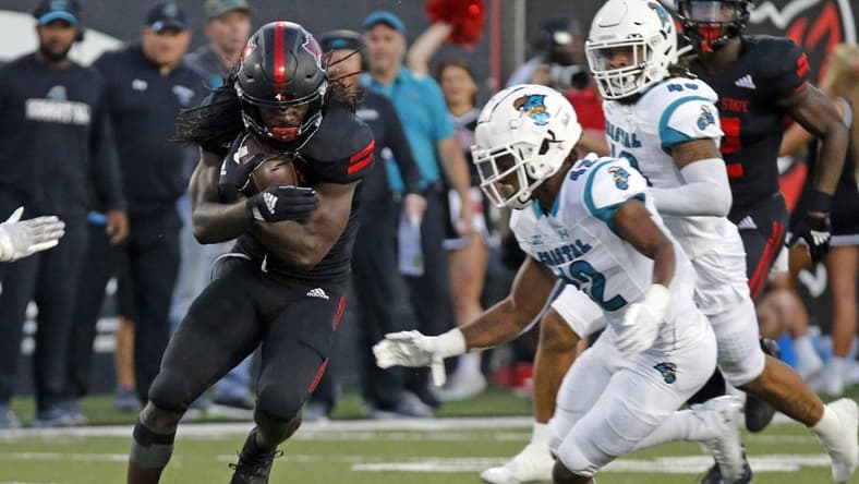 Oct 7, 2021; Jonesboro, Arkansas, USA; Arkansas State Red Wolves wide receiver Te'Vailance Hunt (10) runs after a catch as Coastal Carolina Chanticleers defensive back Tavyn Jackson (42) defends during the first half at Centennial Bank Stadium. Mandatory Credit: Petre Thomas-USA TODAY Sports