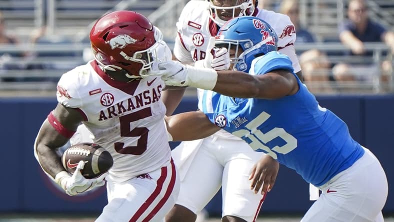 Oct 9, 2021; Oxford, Mississippi, USA; Mississippi Rebels defensive lineman Tavius Robinson (95) grabs the facemark Arkansas Razorbacks running back Raheim Sanders (5) at Vaught-Hemingway Stadium. Mandatory Credit: Marvin Gentry-USA TODAY Sports