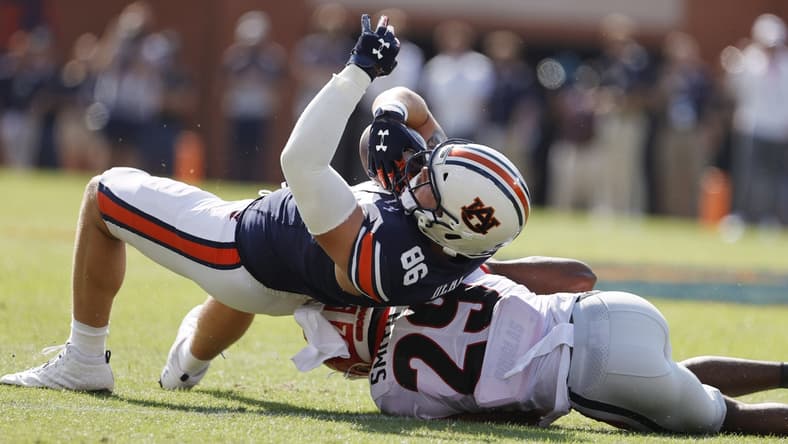 Oct 9, 2021; Auburn, Alabama, USA;  Auburn Tigers tight end Luke Deal (86) rolls over Georgia Bulldogs defensive back Christopher Smith (29) during the first quarter at Jordan-Hare Stadium. Mandatory Credit: John Reed-USA TODAY Sports