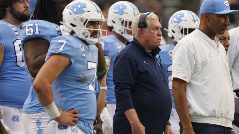 Oct 9, 2021; Chapel Hill, North Carolina, USA; North Carolina Tar Heels head coach Mack Brown looks on from with quarterback Sam Howell (7) the sidelines against the Florida State Seminoles at Kenan Memorial Stadium. Mandatory Credit: James Guillory-USA TODAY Sports
