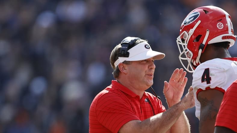 Oct 9, 2021; Auburn, Alabama, USA; Georgia Bulldogs head coach Kirby Smart talks to Georgia Bulldogs linebacker Nolan Smith (4) during the first quarter against the Auburn Tigers at Jordan-Hare Stadium. Mandatory Credit: John Reed-USA TODAY Sports