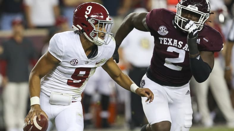 Oct 9, 2021; College Station, Texas, USA; Alabama Crimson Tide quarterback Bryce Young (9) is chased by Texas A&M Aggies defensive lineman Micheal Clemons (2) in the first quarter at Kyle Field. Mandatory Credit: Thomas Shea-USA TODAY Sports