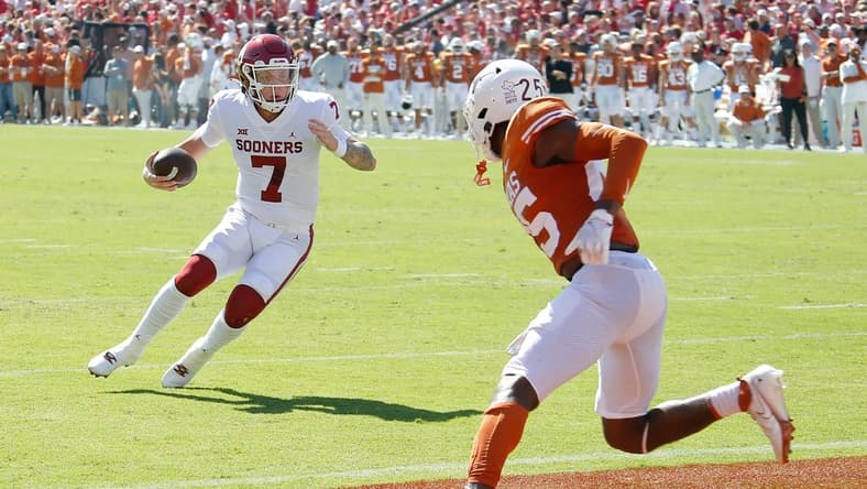 OU quarterback Spencer Rattler (7) runs for a touchdown in front of Texas' B.J. Foster (25) during the first half Saturday in Dallas.

jump
