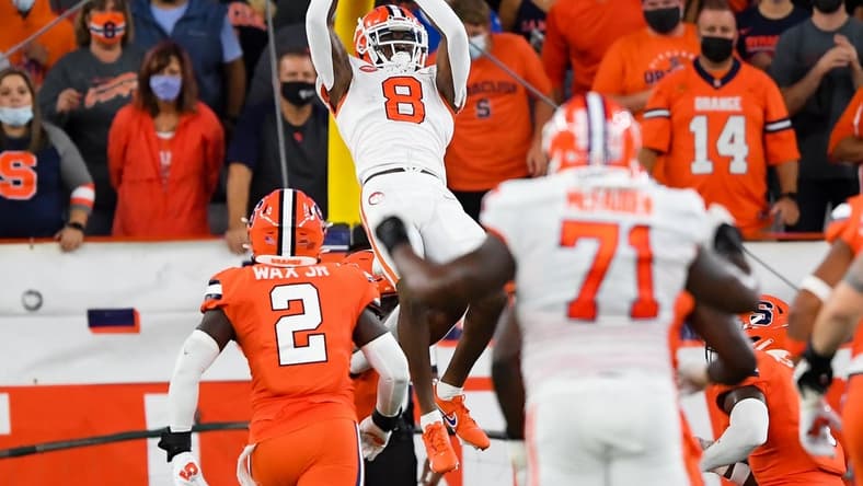Oct 15, 2021; Syracuse, New York, USA; Clemson Tigers wide receiver Justyn Ross (8) catches the ball in front of Syracuse Orange linebacker Marlowe Wax (2) during the first half at the Carrier Dome. Mandatory Credit: Rich Barnes-USA TODAY Sports