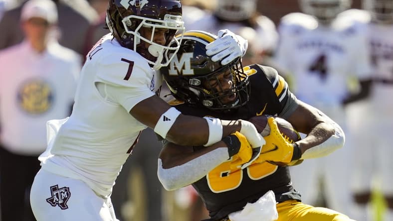 Oct 16, 2021; Columbia, Missouri, USA; Missouri Tigers wide receiver Tauskie Dove (86) is tackled by Texas A&M Aggies defensive back Tyreek Chappell (7) during the first half at Faurot Field at Memorial Stadium. Mandatory Credit: Jay Biggerstaff-USA TODAY Sports
