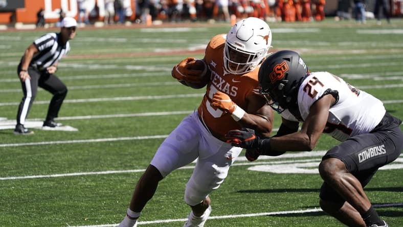 Oct 16, 2021; Austin, Texas, USA; Texas Longhorns running back Bijan Robinson (5) runs for yardage in the red zone in the first half of the game against the Oklahoma State Cowboys at Darrell K Royal-Texas Memorial Stadium. Mandatory Credit: Scott Wachter-USA TODAY Sports