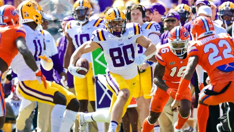 Oct 16, 2021; Baton Rouge, Louisiana, USA; LSU Tigers wide receiver Jack Bech (80) runs against Florida Gators safety Rashad Torrence II (22) during the first half  at Tiger Stadium. Mandatory Credit: Stephen Lew-USA TODAY Sports
