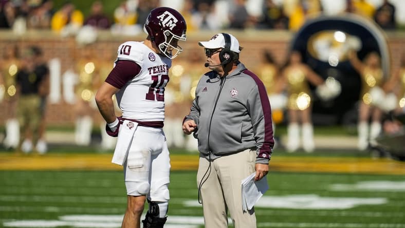 Oct 16, 2021; Columbia, Missouri, USA; Texas A&M Aggies quarterback Zach Calzada (10) talks with head coach Jimbo Fisher during the second half against the Missouri Tigers at Faurot Field at Memorial Stadium. Mandatory Credit: Jay Biggerstaff-USA TODAY Sports