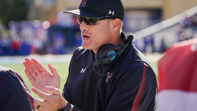 Oct 16, 2021; Lawrence, Kansas, USA; Texas Tech Red Raiders head coach Matt Wells celebrates with players against the Kansas Jayhawks during the first half at David Booth Kansas Memorial Stadium. Mandatory Credit: Denny Medley-USA TODAY Sports