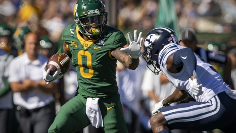 Oct 16, 2021; Waco, Texas, USA; Baylor Bears wide receiver R.J. Sneed (0) stiff arms Brigham Young Cougars defensive back D'Angelo Mandell (5) during the first quarter at McLane Stadium. Mandatory Credit: Jerome Miron-USA TODAY Sports