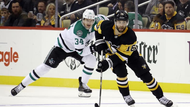 Oct 19, 2021; Pittsburgh, Pennsylvania, USA; Pittsburgh Penguins left wing Jason Zucker (16) sites up ice with the puck ahead of Dallas Stars right wing Denis Gurianov (34) during the second period at PPG Paints Arena. Mandatory Credit: Charles LeClaire-USA TODAY Sports