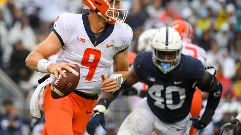 Oct 23, 2021; University Park, Pennsylvania, USA; Illinois Fighting Illini quarterback Artur Sitkowski (9) runs with the ball past Penn State Nittany Lions linebacker Jesse Luketa (40) during the first half at Beaver Stadium. Mandatory Credit: Rich Barnes-USA TODAY Sports