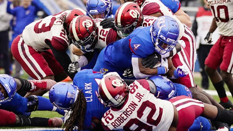 Oct 23, 2021; Lawrence, Kansas, USA; Kansas Jayhawks running back Devin Neal (4) scores a touchdown against the Oklahoma Sooners during the first half at David Booth Kansas Memorial Stadium. Mandatory Credit: Jay Biggerstaff-USA TODAY Sports